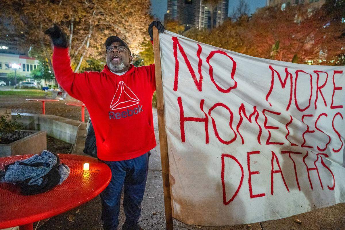Brother Kevin Carter of the Sacramento Poor People’s Campaign holds a banner that says "No more homeless deaths" during a vigil at Cesar E. Chavez Plaza in Sacramento on Sunday to memorialize people who died this year while homeless in Sacramento County. Carter spoke against government policies, saying they were not helping the unhoused, at the event. 