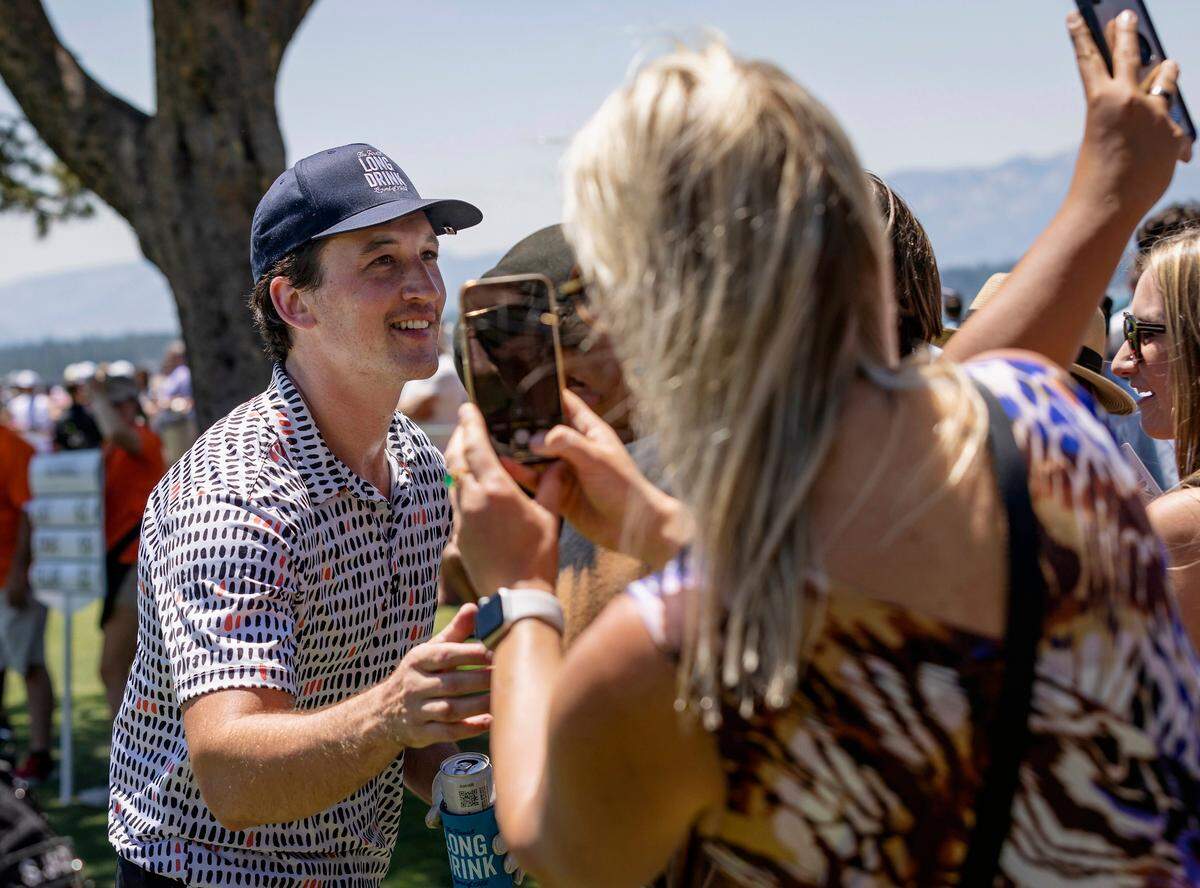 Miles Teller takes photos with fans on the eighteenth hole during the American Century Celebrity Golf Championship Tournament on Sunday, July 10, 2022, at Edgewood Tahoe Golf Course in Stateline, NV.