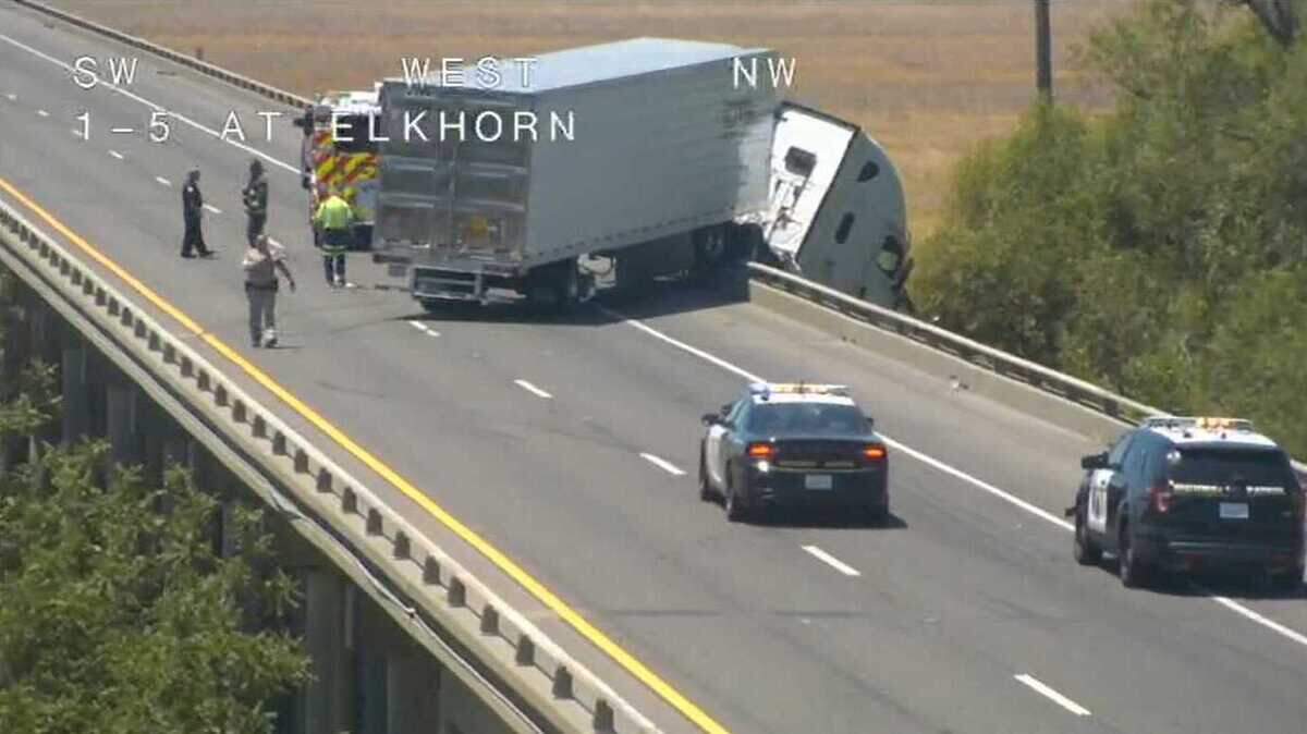 A big rig was hanging off the Yolo bypass bridge on Interstate 5 near Sacramento International Airport Friday June 25, 2021. after it crashed and blocked northbound traffic for miles.