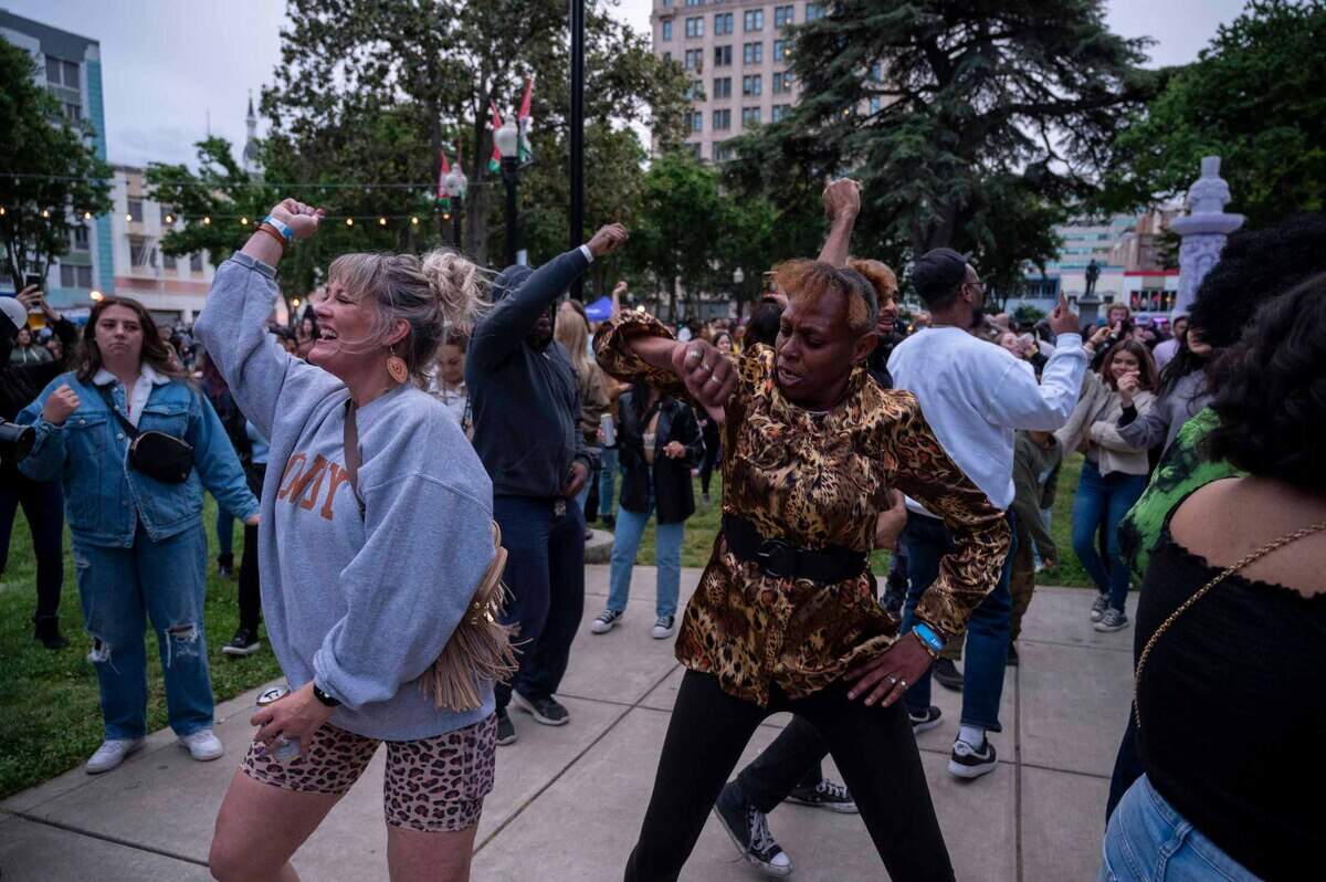 Alicia Francies, left, Marsha Deas dance to live music at Cesar Chavez Plaza on opening night of the Concerts in the Park, a three-month free concert series that began on Cinco de Mayo.