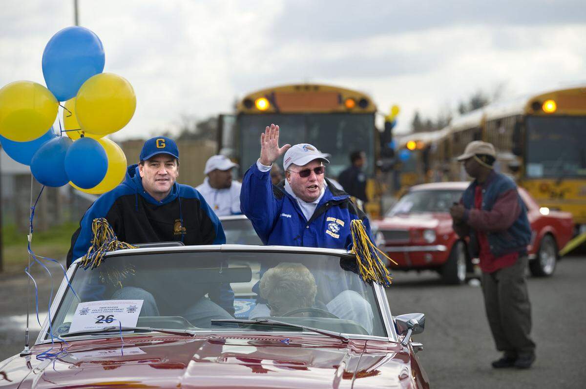 Grant High School football head coach Mike Alberghini waves to well wishers as he and Principal Craig Murray celebrate the school’s state championionship with at parade and rally to City Hall on Dec. 22, 2008.