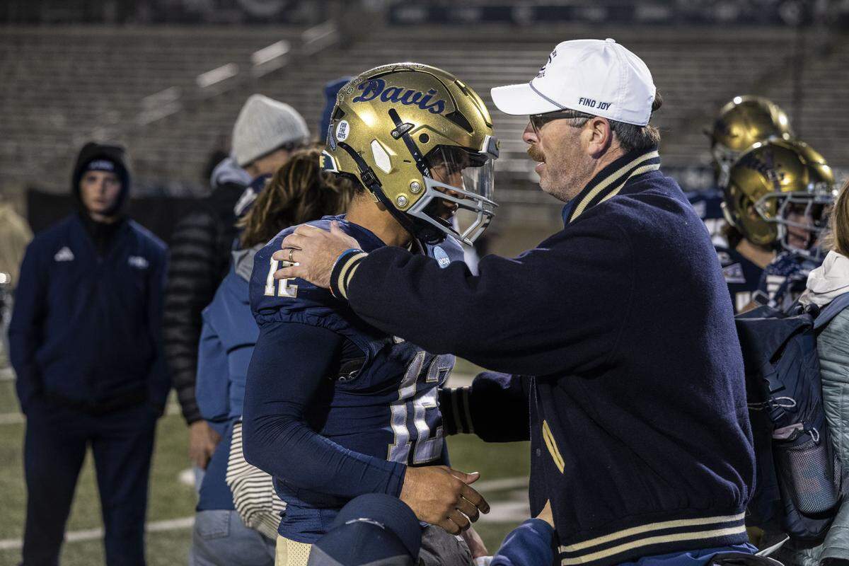 UC Davis Aggies quarterback Caden Pinnick (12) is comforted by coach Tim Plough after their team’s 42-31 loss to Illinois State during a NCAA FCS playoff quarterfinal at UC Davis Health Stadium on Saturday, Dec. 13. Pinnick transferred to Washington State after the 2025 season.