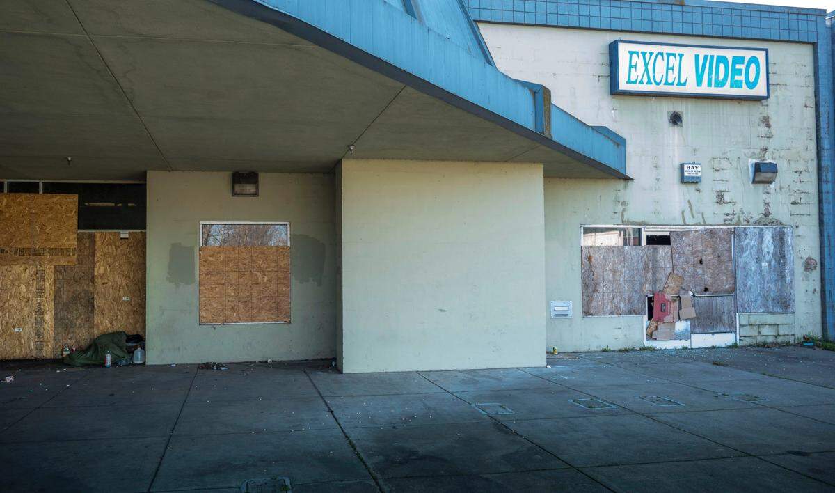 A sign for Excel Video hangs above the boarded up shop in the former Peach Tree Mall in Linda on Thursday as the demolition of the structure is underway. The mall never reopened after it was flooded in a 1986 levee break on the Yuba River.