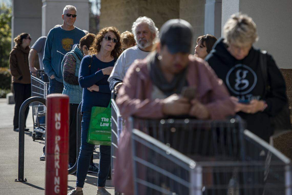Customers wait on line outside of a Winco grocery store on Fairway Drive in Roseville on Friday, March 20, 2020, as the store tries to limit the number of people inside to help slow the spread of the coronavirus. California Gov. Gavin Newsom on Thursday ordered state residents to stay home during the pandemic, with the exception of essential activities.