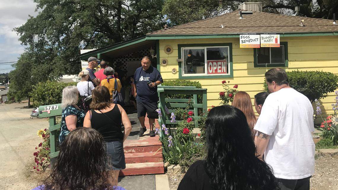 A line of people wait to enter the El Dorado Cafe on Sunday.
