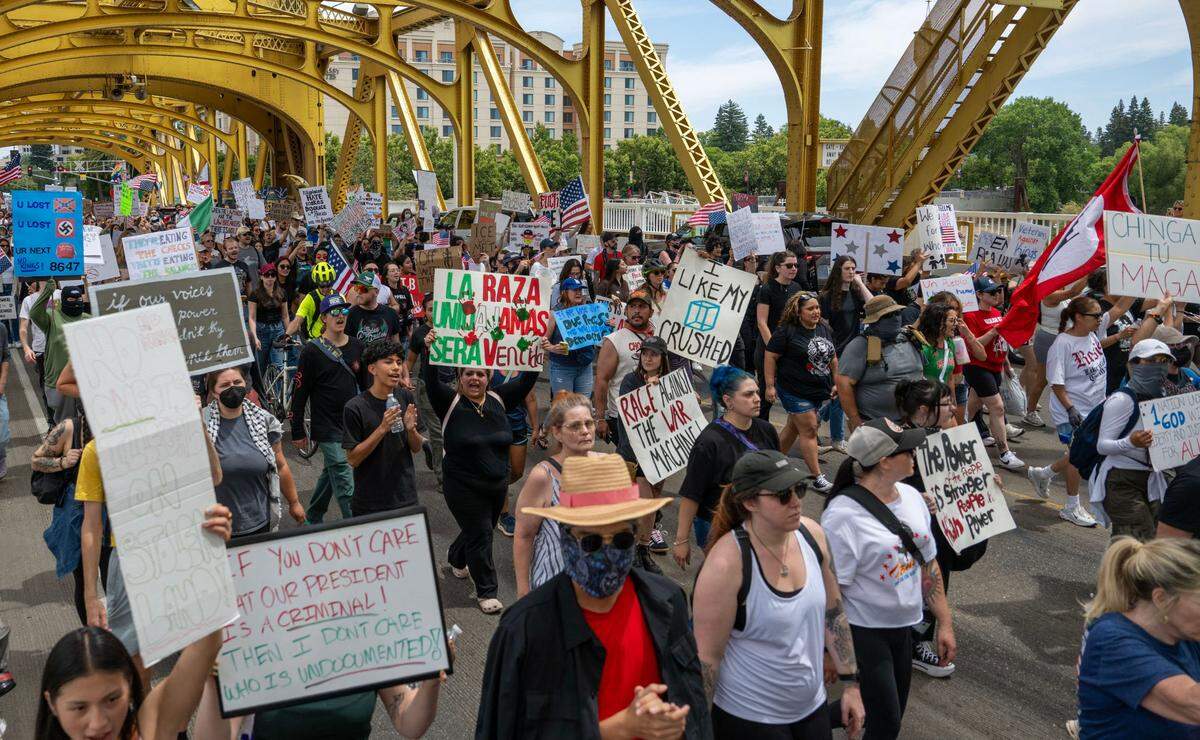 Protesters march on the Tower Bridge during “No Kings” protest against the Trump administration in downtown Sacramento on June 14.