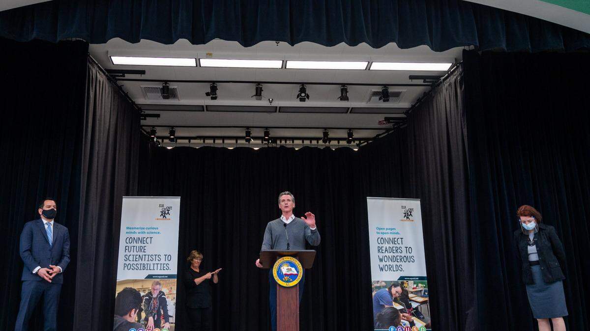 California Gov. Gavin Newsom, center, Assembly Speaker Anthony Rendon, left, and Senate President pro Tempore Toni Atkins, right, announce a deal to reopen schools at a press conference at Franklin Elementary School in Elk Grove on Monday, March 1, 2021.