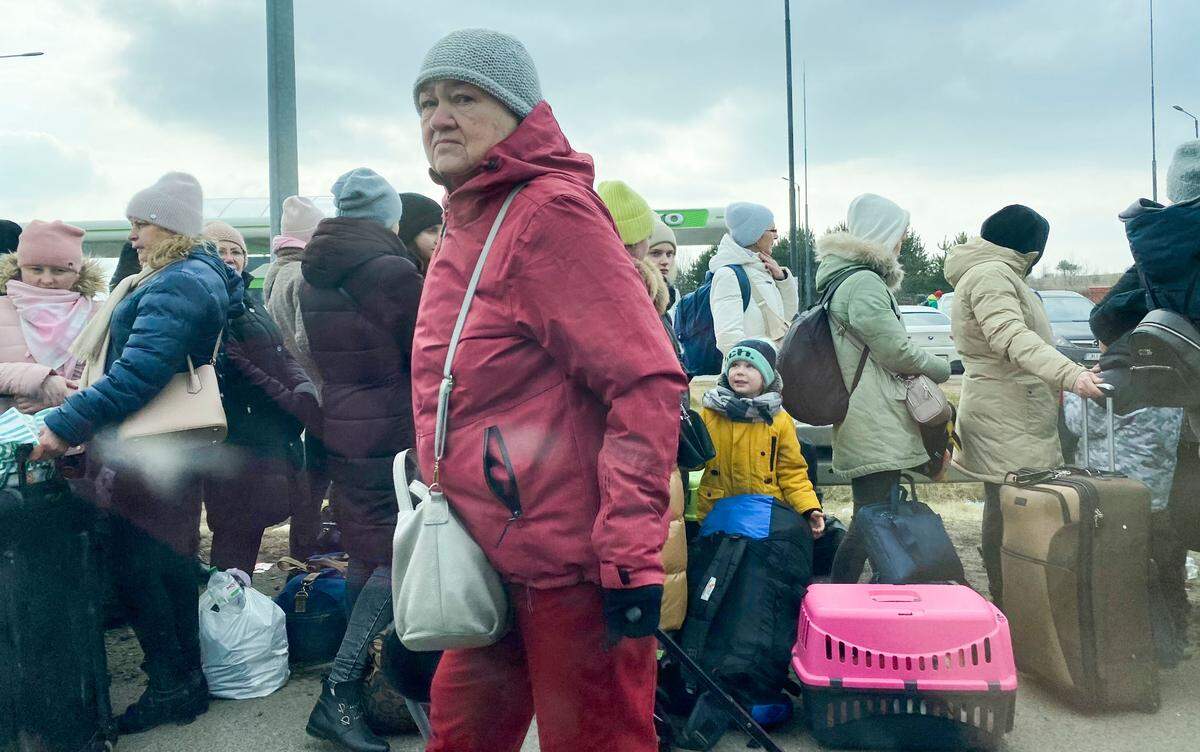 Ukranian refugees wait at the Polish border, mostly elderly and women with children. For many, their husbands, fathers and sons all stayed behind.