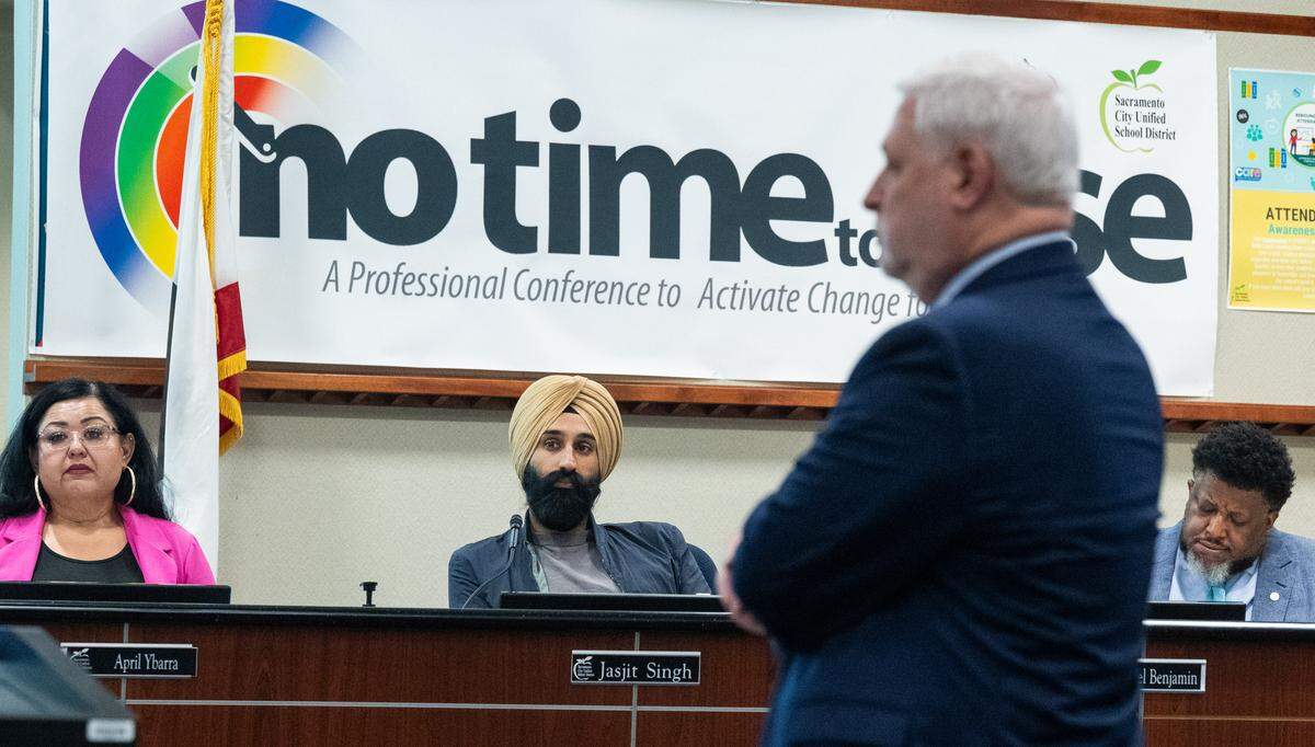 Sacramento City Unified trustee Jasjit Singh, center, listens as a member of the Fiscal Crisis and Management Assistance Team reviews Sacramento City Unified School District’s financial situation during a meeting at the Serna Center on Thursday.