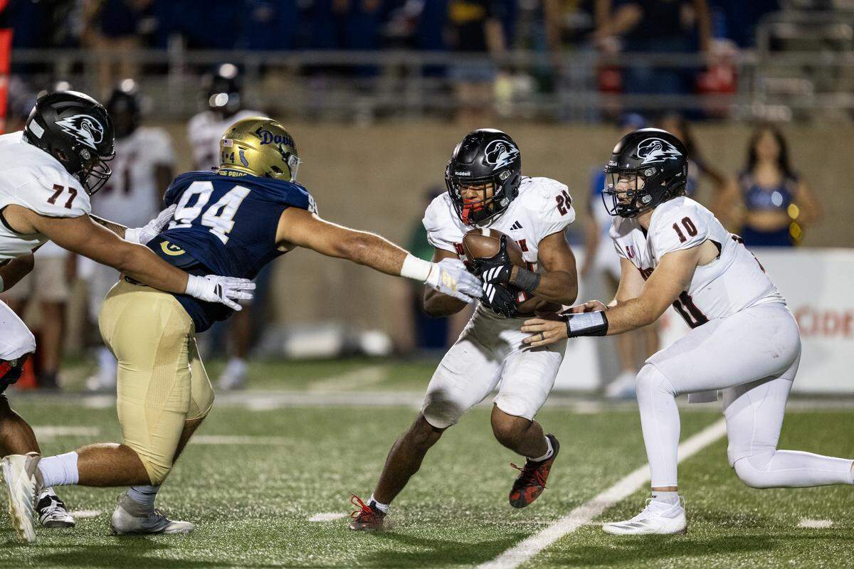 Southern Utah Thunderbirds running back Joshua Dye (28) is stopped behind the line of scrimmage by UC Davis Aggies defensive lineman Jacob Psyk (94) in the first half on Saturday.
