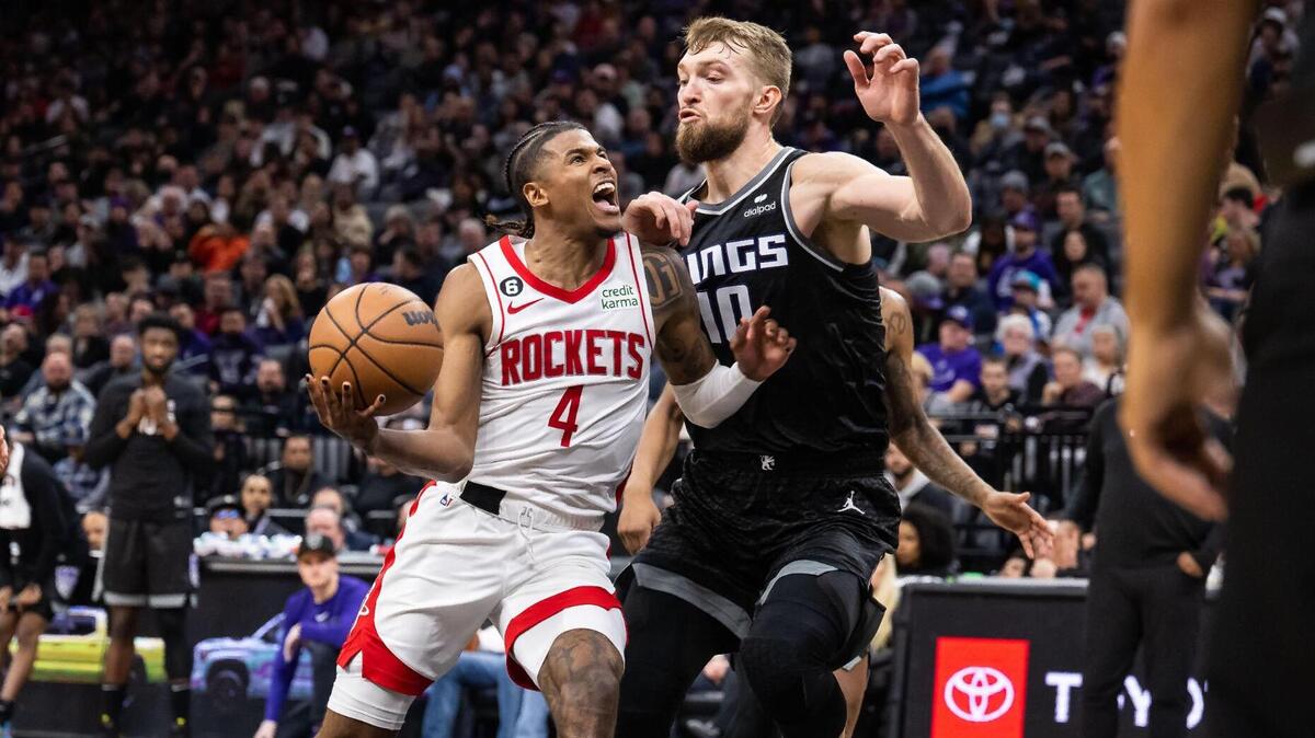 Houston Rockets guard Jalen Green (4), center, drives to the basket but misses as Sacramento Kings center Domantas Sabonis (10) applies pressure during the third quarter of the NBA basketball game Wednesday, Jan. 11, 2023, at Golden 1 Center in Sacramento. The Kings beat the Rockets, 135-115.