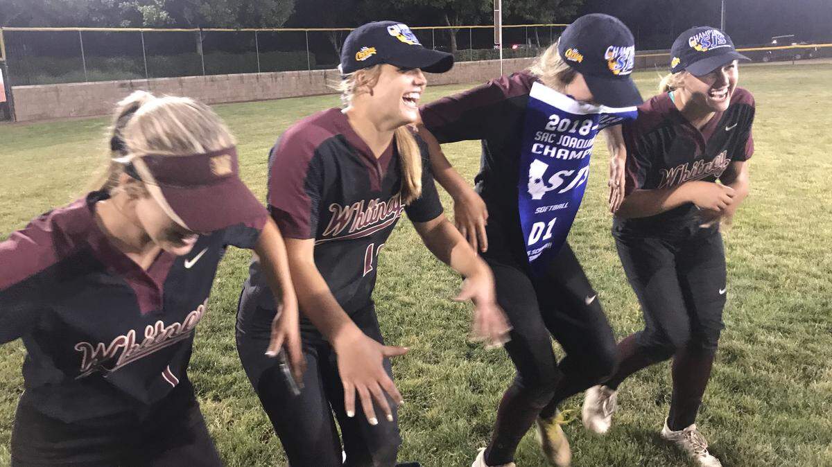 Whitney High School softball players dance in celebration of their first Sac-Joaquin Section Division I championship Friday in Stockton. The Wildcats beat Tracy 16-6 for the title.