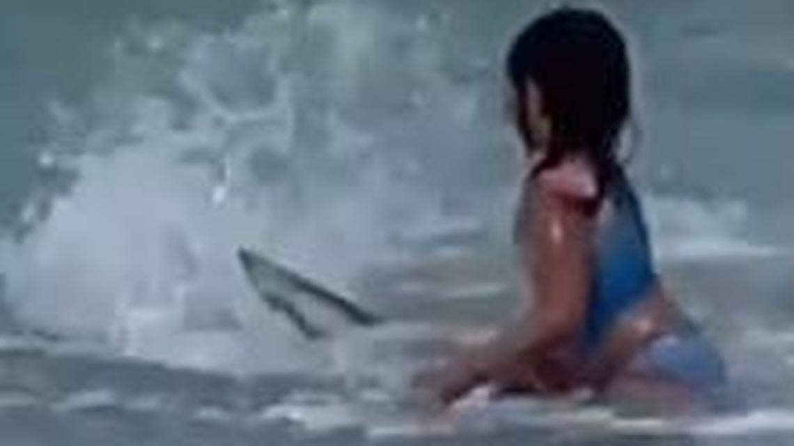 A video shot by her mother shows Anela Rezentes, 6, of Hawaii react when she spots a shark in the surf nearby at an Oahu beach.