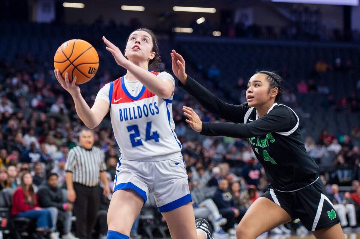 Folsom Bulldogs guard Sophia Mindermann (24) scores a layup past St. Mary’s Rams guard Mia Jamias (14) in the second half in CIF Sac-Joaquin Section Division I girls basketball Championship on Saturday, Feb. 25, 2023, at Golden 1 Center in Sacramento. Mindermann had 12 points. The Bulldogs 58-53.