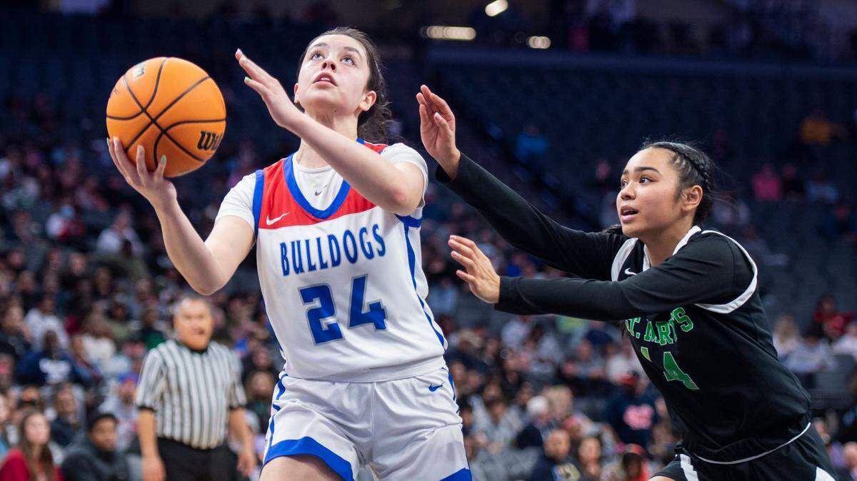Folsom Bulldogs guard Sophia Mindermann (24) scores a layup past St. Mary’s Rams guard Mia Jamias (14) in the second half of the 2023 CIF Sac-Joaquin Section Division I girls basketball championship at Golden 1 Center.
