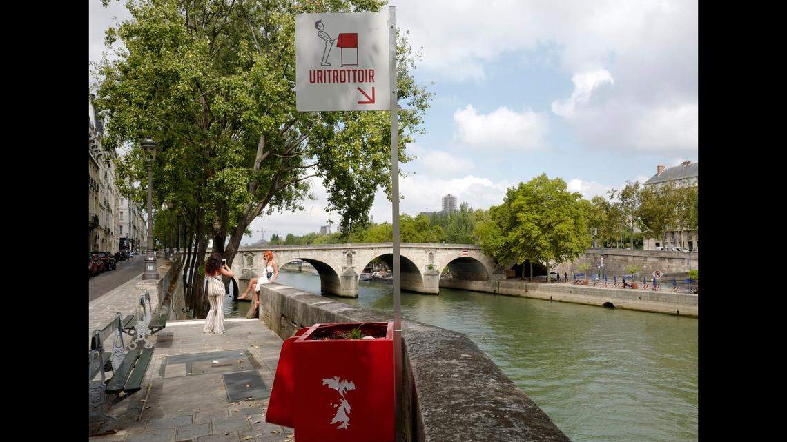 One of the red outdoor urinals was installed next to the Seine River on the Ile de la Cite in Paris.