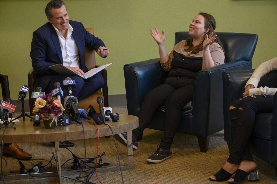 California Governor Gavin Newsom and Megan Colbert compare notes on raising toddlers as she shares her struggles as a single parent while talking about affordable housing issues on Tuesday, March 26, 2019 in Sacramento. Newsom held a round table discussion to address housing affordability and rising rents.