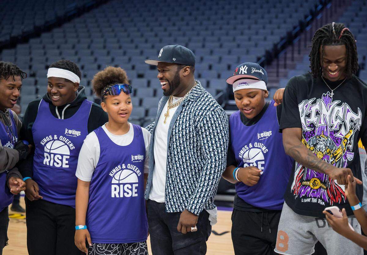 Entertainer and businessman Curtis “50 Cent” Jackson, center, is flanked by 11-year-old Ayanah Mims, left, and 13-year-old Keshawn Stone, both representing Valley Hi, as they are photographed alongside Sacramento Kings guard Keon Ellis during an event presented by Jackson’s G-Unity Foundation at Golden 1 Center on Saturday, June 10, 2023, to kick off the sixth season of the Kings and Queens Rise Co-Ed Youth Sports and Mentoring League. “It’s fun … you get to meet new people and get new friends,” Mims said about basketball, adding she’s been playing since she was 2 years old. The league, a partnership with The Center at Sierra Health Foundation’s Black Child Legacy Campaign and My Brother’s Keeper Sacramento, aims to prevent violence and create positive connections by engaging youth from eight neighborhoods in activities during the summer months.