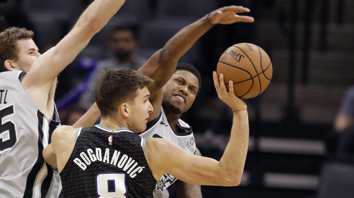 Kings guard Bogdan Bogdanovic passes to a teammate as San Antonio Spurs forward Rudy Gay, right, defends Monday at Golden 1 Center. Bogdanovic led the Kings with 22 points in a 104-99 victory.
