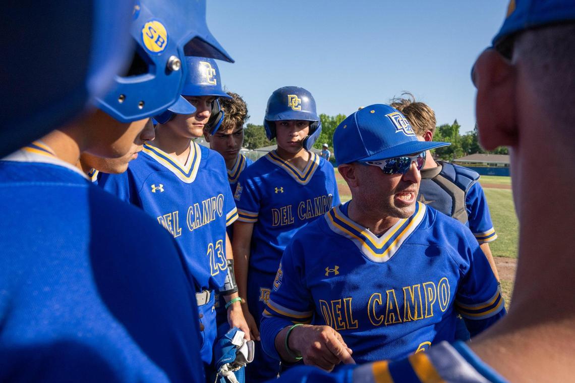 Del Campo Cougars head coach Kevin Dawidczik speaks with players in a first-round Sac-Joaquin Section Division IV baseball playoff game on Wednesday, May 7, 2024, in Fair Oaks.