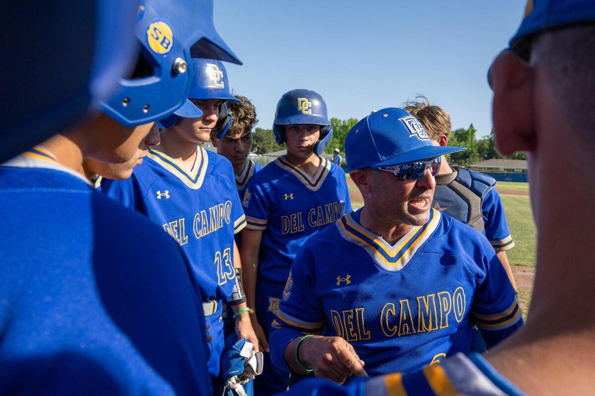 Del Campo Cougars head coach Kevin Dawidczik speaks with players in a 2024 first-round Sac-Joaquin Section Division IV baseball playoff game.