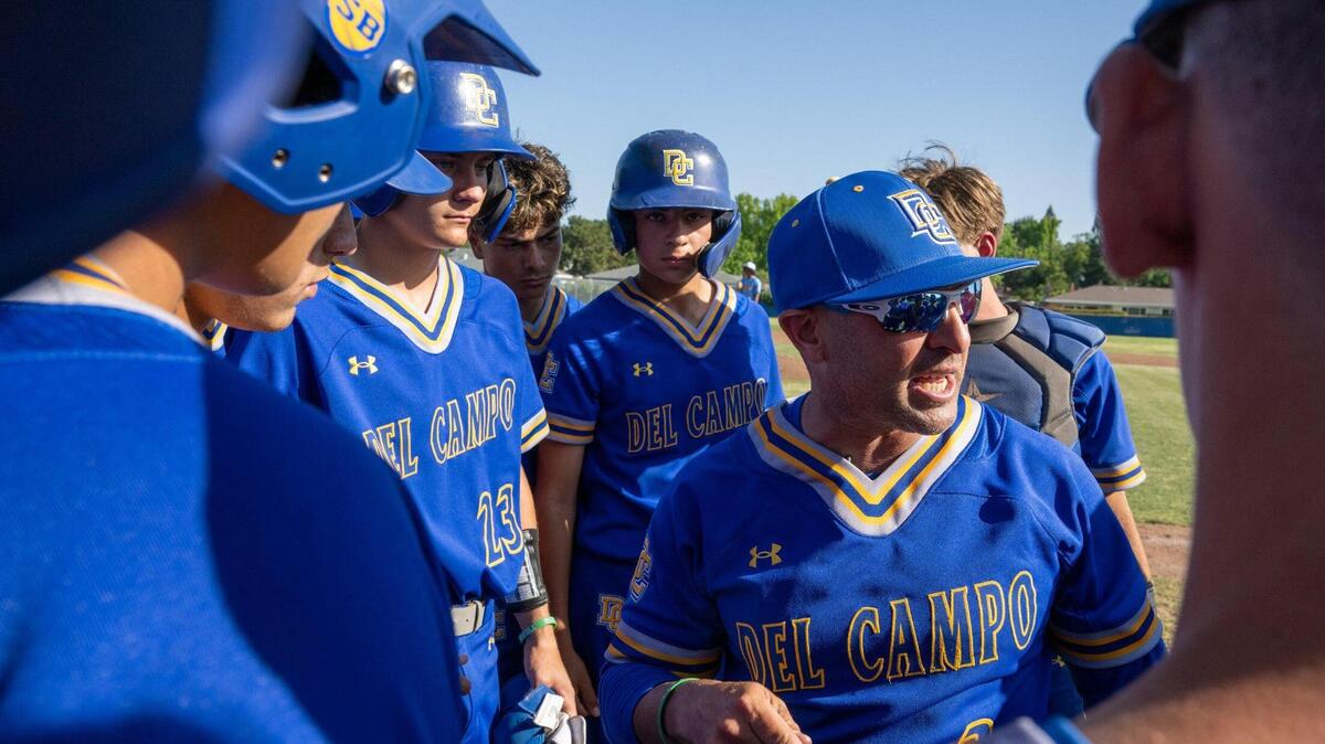 Del Campo Cougars head coach Kevin Dawidczik speaks with players at a 2024 Sac-Joaquin Section Division IV baseball playoff game in Fair Oaks. Dawidczik is joining Jesuit as an associate head coach under Joe Potulny.