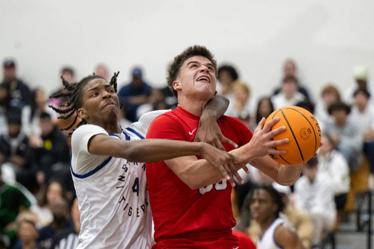 The Inderkum Tigers’ Taylen Goodman (4) fouls the Folsom Bulldogs’ Ryder Lyons (33) as he shoots in the first half of a CIF Sac-Joaquin Section Division I semifinal basketball game Tuesday, Feb. 25, 2025 in Sacramento.