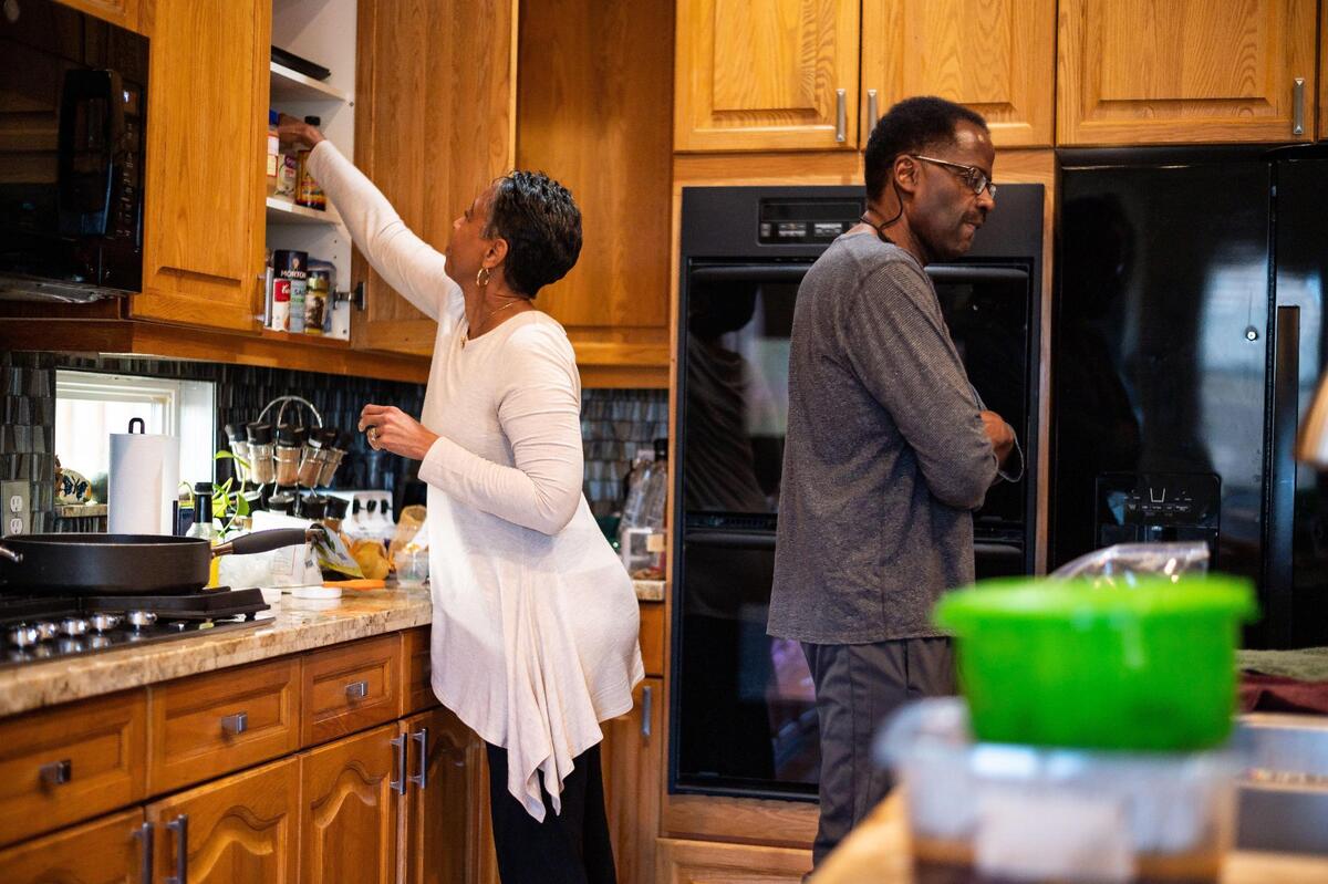 Carla Preyer prepares a meal for her husband of nearly 20 years, Patrick Preyer, in their kitchen at home Wednesday, Feb. 24, 2021, in Rancho Cordova. Patrick was diagnosed with Lewy body dementia. “The loved ones that are there in the home, they can tell you,” Carla said. “They can tell you when something is different.” It took about four years for his diagnosis, she added. She volunteers with the Alzheimer’s Association to promote their efforts to help with early diagnosis of dementia.