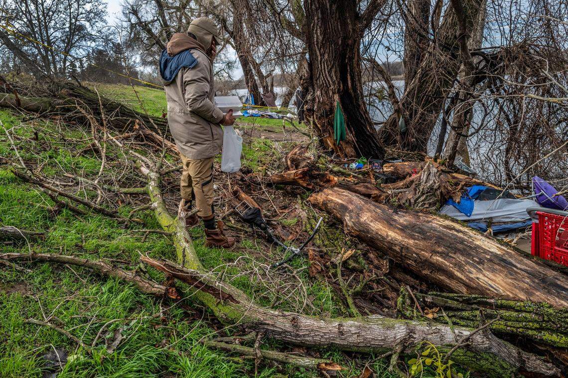 David Howard mourns on Monday the death of his friend Rebekah Rohde, 40, a homeless woman who died Saturday when a tree crushed her tent near the levee at the end of North Fifth Street in Sacramento. Howard said he gave her the green coat that hangs on the tree to shield her from the rain.