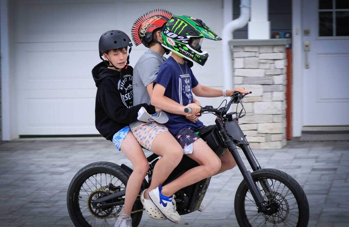 Children ride an e-bike in Point Pleasant, New Jersey, in 2025. Sales of e-bikes have surged in recent years, prompting schools, law enforcement agencies and lawmakers in California to address safety and regulatory concerns as more young riders use the devices.