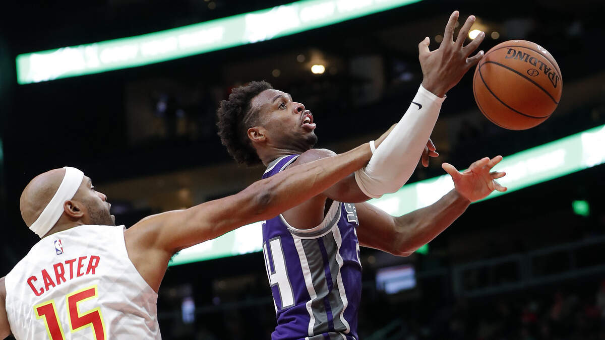 Kings guard Buddy Hield is fouled by Atlanta Hawks forward Vince Carter on Thursday in Atlanta. Hield was second on the team in scoring with 27 points in the Kings’ 146-115 victory, Sacramento’s fifth in a row.