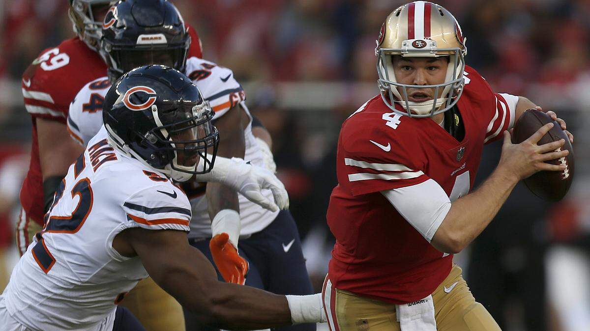 San Francisco 49ers quarterback Nick Mullens (4) scrambles away from Chicago Bears outside linebacker Khalil Mack (52) in the first half Sunday, Dec. 23, in Santa Clara.