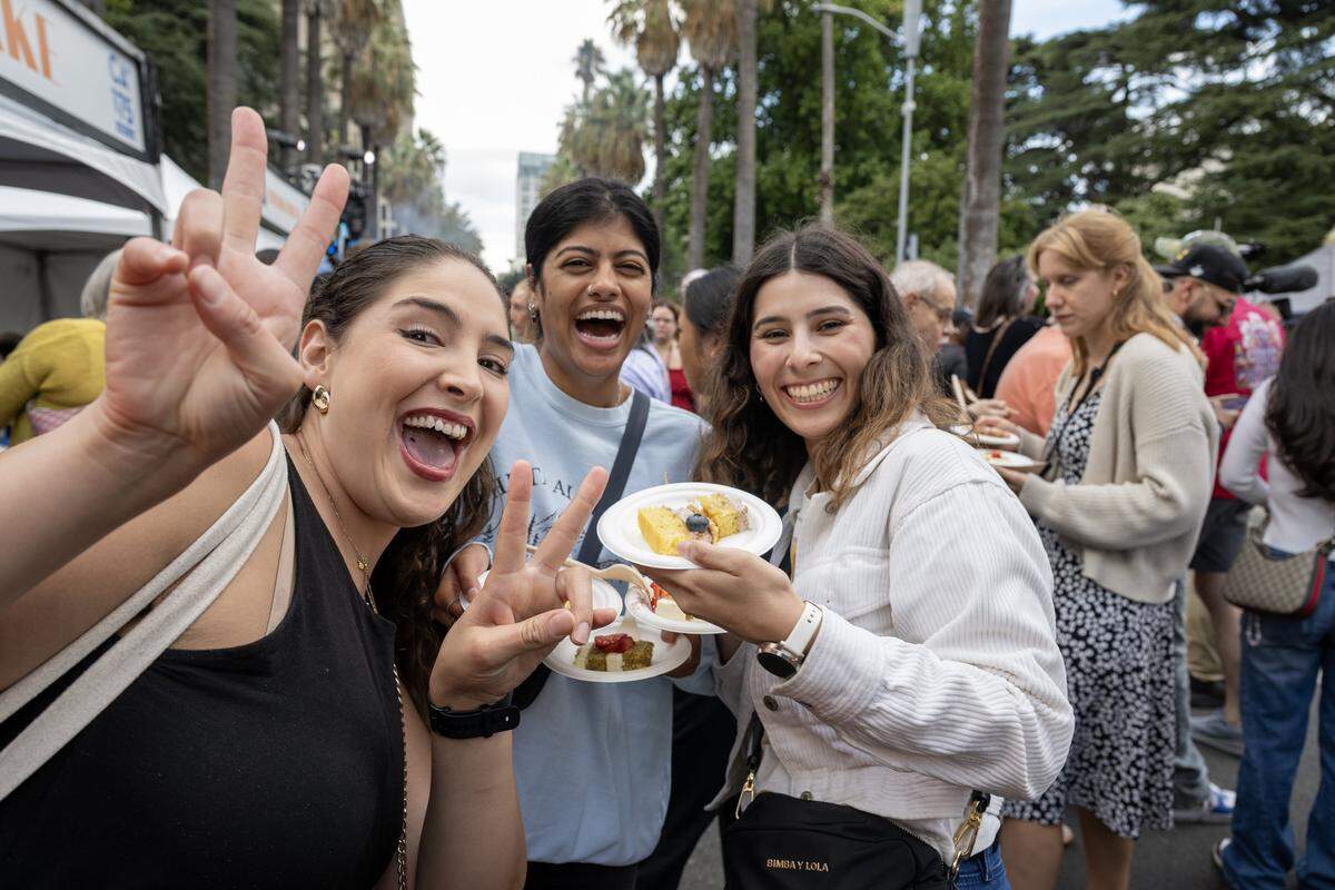 Visitors enjoy free cake during a 175th birthday block party to celebrate California's anniversary of statehood on Tuesday, Sept. 9, 2025, at the state Capitol.