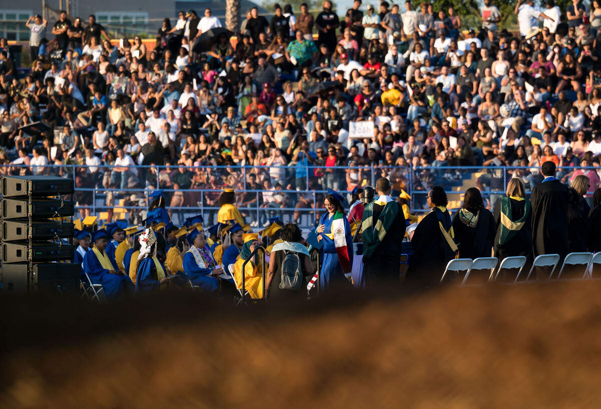 A Grant Union High School graduating senior walks across the stage Thursday, June 1, 2023, during the graduation ceremony at the Sacramento school. Many attendees had to watch or listen from outside the stadium after it was announced that capacity had been reached.