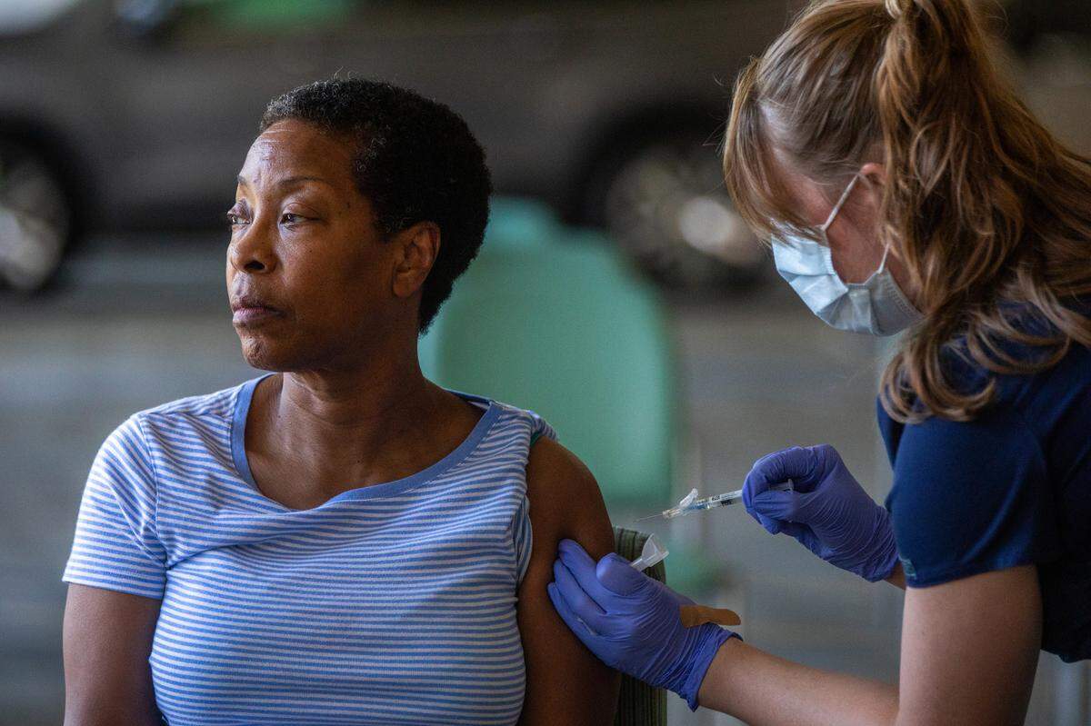 A patient receives her COVID-19 vaccine during a flu and COVID-19 vaccination clinic at Kaiser Permanente Pasadena on Oct. 12, 2023, in Pasadena.