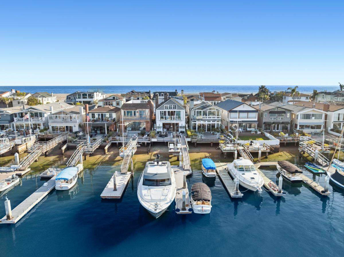 Other highlights of the $13.5 million Newport Beach home include a rooftop deck with a spa, bayfront terrace, backyard firepit and private dock.