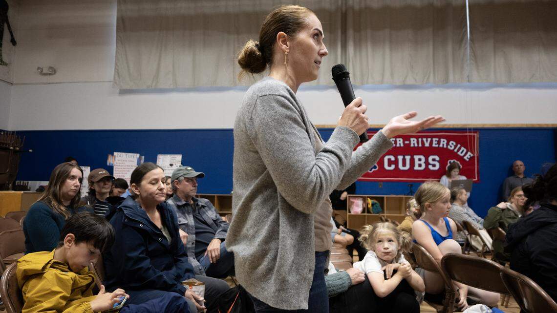 Tiffany McFarland Olcese voices her concern about replacing the existing grass field at Crocker/Riverside Elementary School with artificial turf during a community meeting at the school on Tuesday.