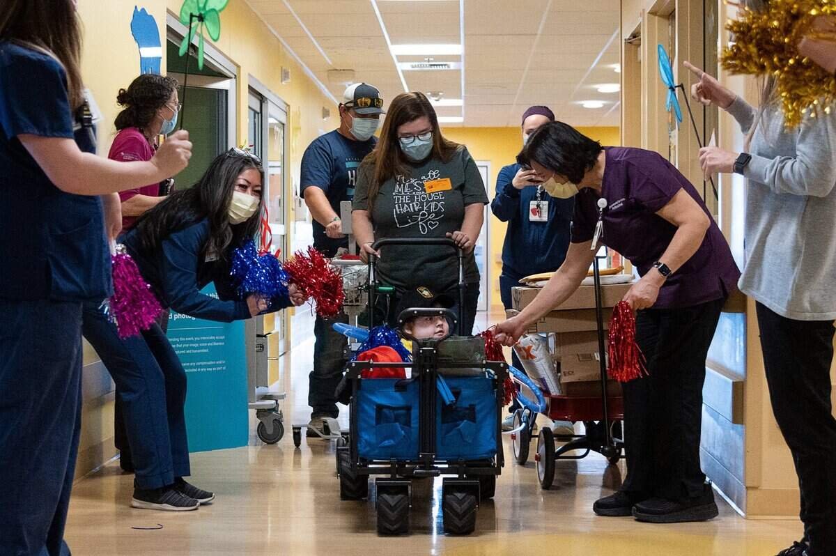 24. Noah Schneider, 5, leaves the Sutter Medical Center, Sacramento with his parents Haley and Andrew Schneider of Yuba City on Monday, March 1, 2021, as nurses and other hospital staff cheer. Noah, who had COVID-19 in addition to his cystic fibrosis, is going home after two months in the hospital.