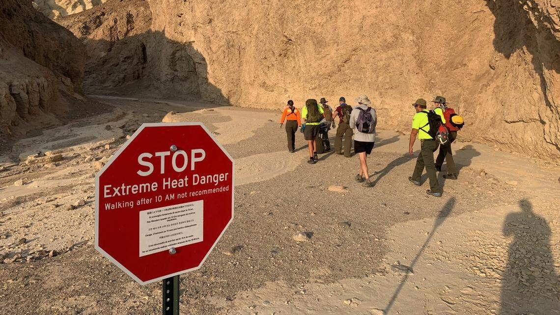 A rescue team sets out on the Golden Canyon Trail in Death Valley. A 60-year-old San Francisco man died Aug. 18 on the trail, possibly of heat stroke, rangers say.