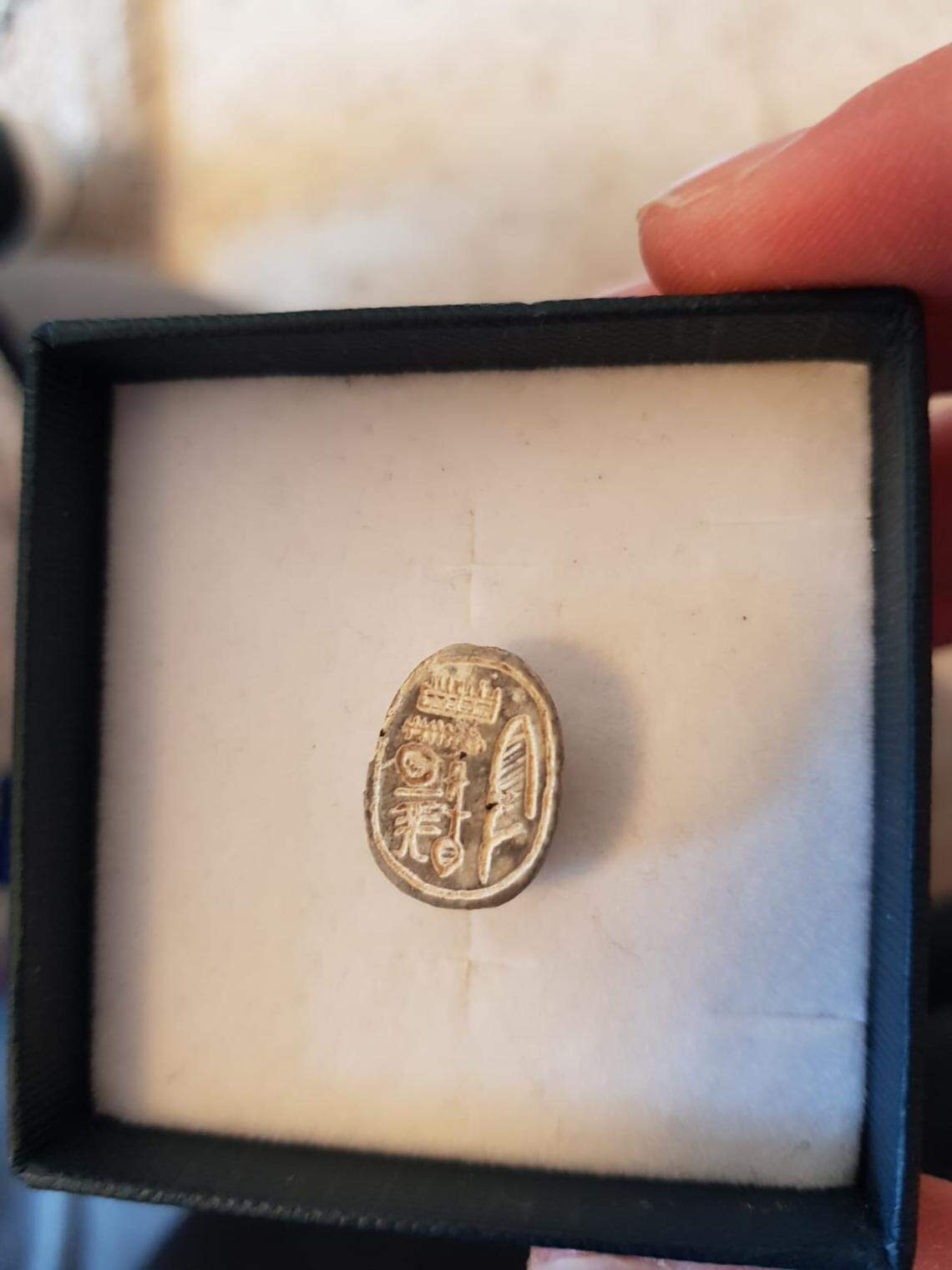 The photo shows the intricately carved back of the scarab seal.