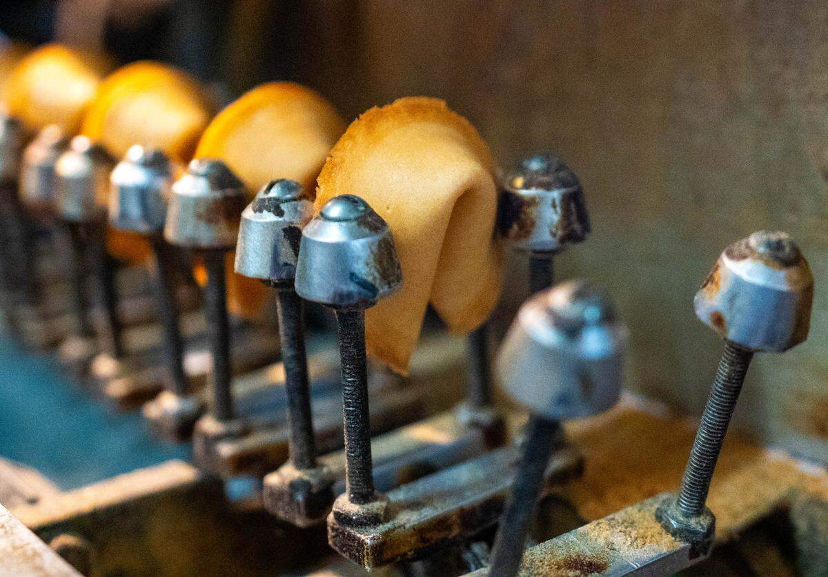 Fortune cookies make their way towards the end of the assembly line at New World Co. on Tuesday, April 23, 2024.