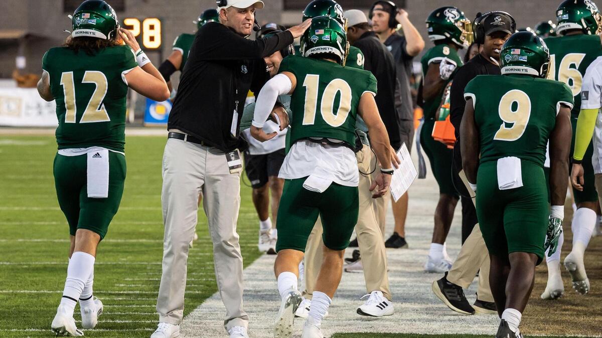 Sacramento State head coach Troy Taylor congratulates his players after scoring the game’s first points against Utah Tech during the first quarter of the NCAA college football game Saturday, Sept. 3, 2022, at Hornet Stadium in Sacramento.