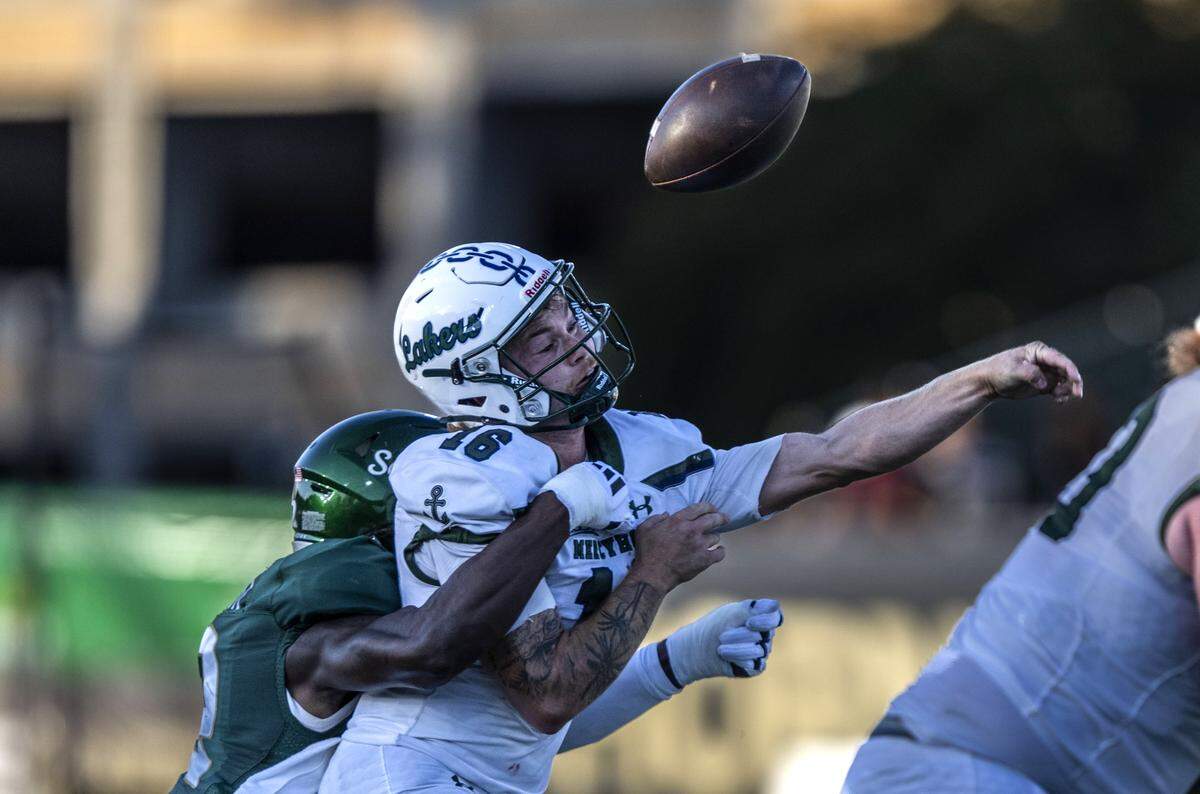 Sacramento State Hornets linebacker Deven Wright (2) forces Mercyhurst Lakers quarterback Adam Urena (16) to lose the ball as he throws a pass during the first quarter an NCAA football game at Hornet Stadium on Saturday. The play was called a fumble but later overturned.