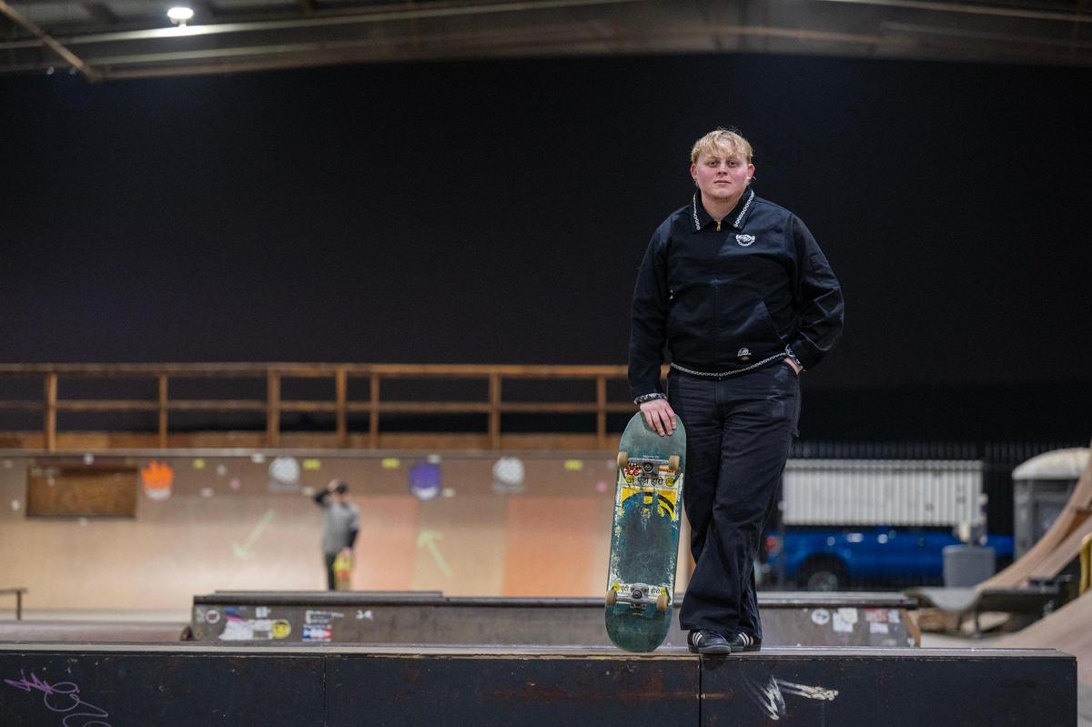 Jesse Stanfill, a site leader for Project Lifelong, stands with a skateboard at 28th & B skate park in Sacramento on Thursday, Dec. 19, 2024. He said skateboarding has given him the opportunity to meet people and express himself.