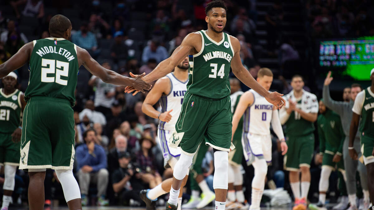 Milwaukee Bucks forward Giannis Antetokounmpo (34) is congratulated by Milwaukee Bucks forward Khris Middleton (22) after scoring a basket during a game at the Golden 1 Center in Sacramento, Wednesday, March 16, 2022.