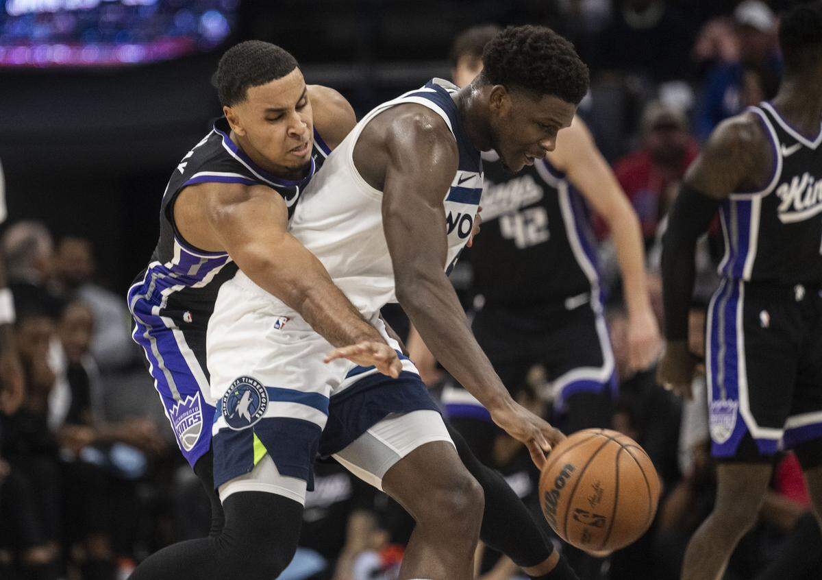 Sacramento Kings forward Keegan Murray (13) steals the ball from Minnesota Timberwolves guard Anthony Edwards (5) during an NBA game at Golden 1 Center on Monday.