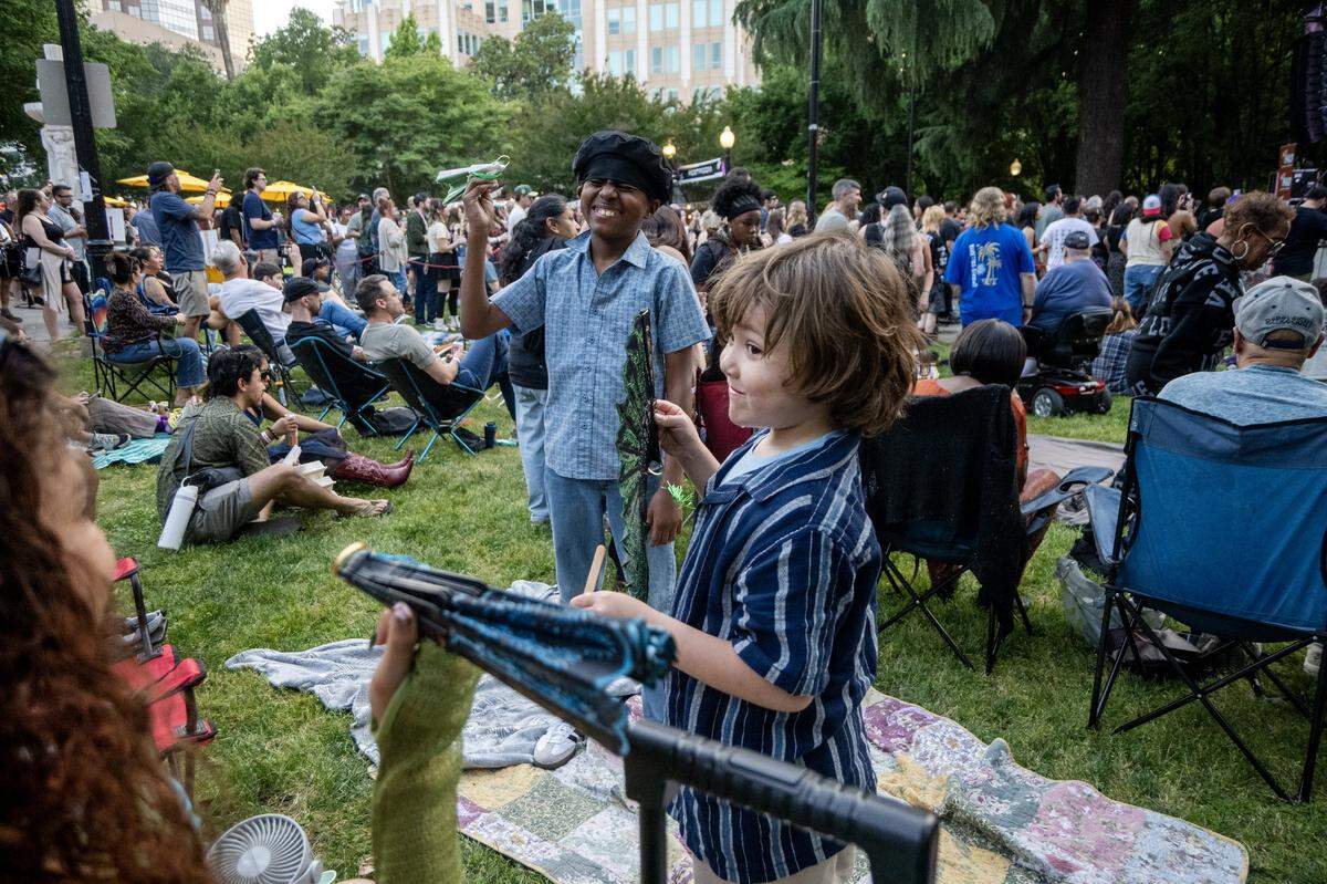 Liam McKean-Craig and Silas McKean enjoy family time during Concert in the Park across from Sacramento City Hall on Friday.
