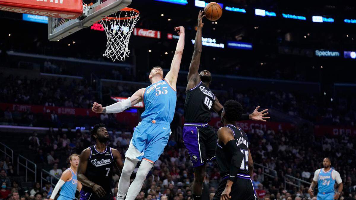 Sacramento Kings center Neemias Queta (88) grabs a rebound next to Los Angeles Clippers center Isaiah Hartenstein (55) during the first half of an NBA basketball game Saturday, April 9, 2022, in Los Angeles. (AP Photo/Marcio Jose Sanchez)