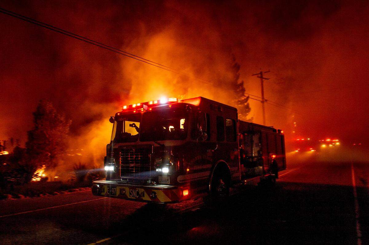 A fire engine drives past the Soda Rock Winery in Healdsburg on early Sunday morning, Oct. 27, 2019, as the Kincade Fire expands.