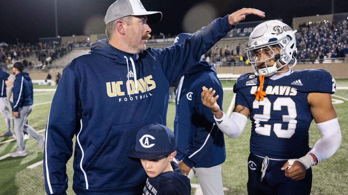 UC Davis Aggies head coach Tim Plough talks to tight end Winston Williams (23) after their 30-28 loss to the Montana State Bobcats on Nov. 16 at UC Davis Health Stadium. Plough’s team will host Illinois State in the FCS playoffs this coming Saturday.